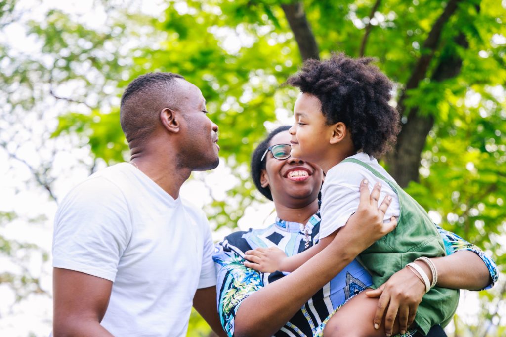 Love moment of Happy African American family in the park in springtime